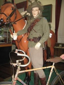 Old bicycle and mannequin in uniform in war museum