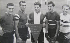 Four cyclists with winning pennant